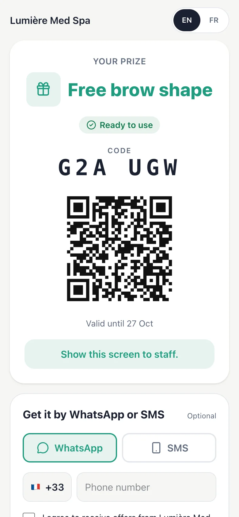 Spin on a phone. The coupon with its code and QR code, ready for staff to redeem.